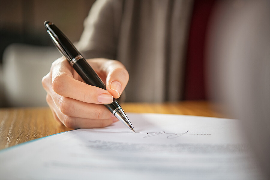 Close up of woman hand applying for signature loans for bad credit.