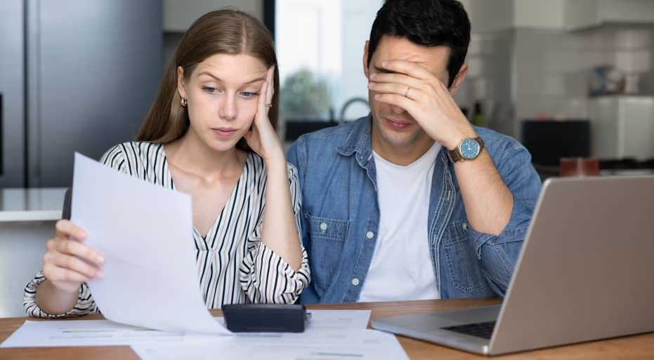 Stressed couple looking at bills